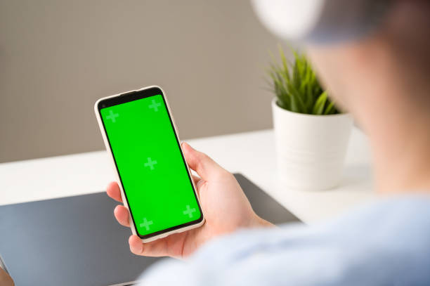 istock Modern aplications mickup.Smartphone with green chroma screen in hands of unrecognizable man 1700531881