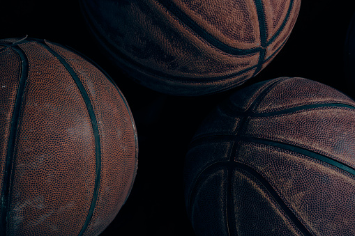 Worn basketballs on a black background