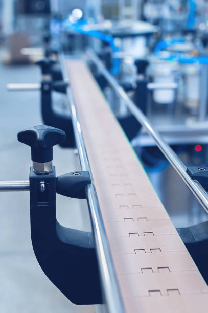 istock An empty production line conveyor belt at an equipment assembly plant. Toned image. 1700535772