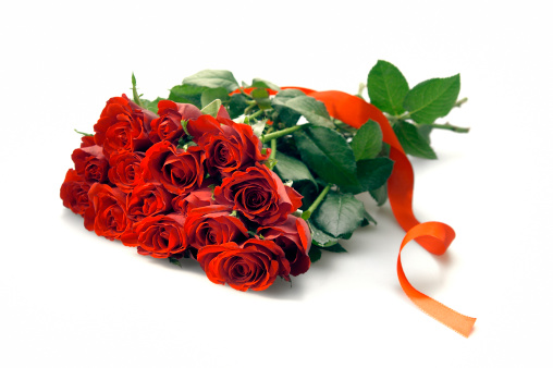 bouquet of red roses and red ribbon on white background