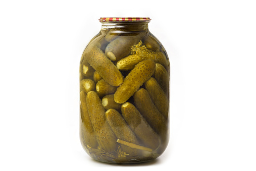 Jar of canned cucumbers isolated on white background. Pickled cucumbers in a glass jar.