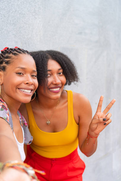 istock two African-American friends with a broad smile on their faces. 1700553256