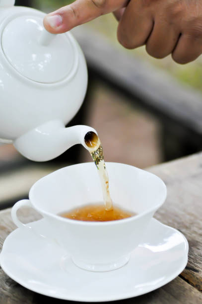 istock hot tea ,kettle and tea cup or pouring tea 1700553266