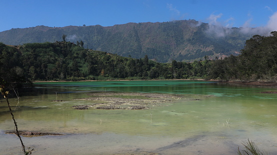 Volcanic lake Telaga Warna at plateau Dieng