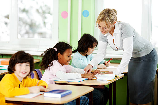 istock Teacher explaining tasks to a schoolgirl. 170055879