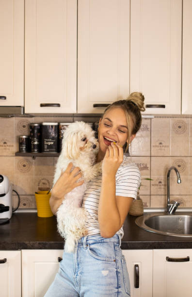 istock A girl and her dog in the kitchen 1700558914