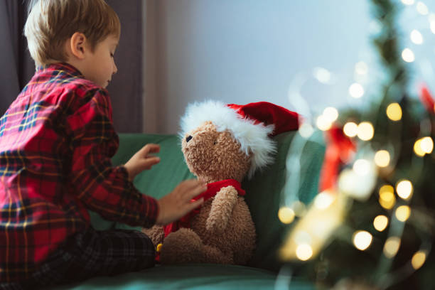 istock cute little boy dressing up teddy bear 1700566662