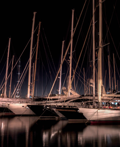 istock Sailing yachts in harbor at night 1700572352