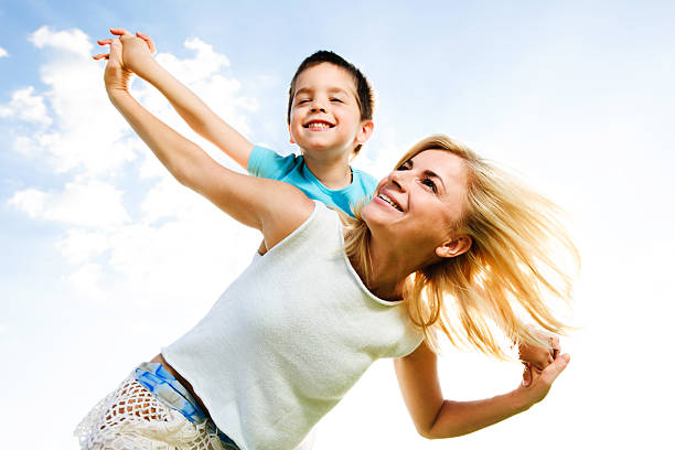 istock Beautiful mother giving her son a piggyback ride. 170057288