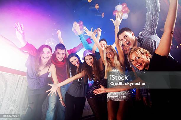 Group Of Young People With Arms Raised At A Club Stock Photo - Download Image Now - Celebration, Low Angle View, Photography