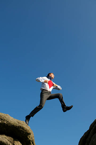 istock Businessman Superhero Leaps Across Valley 170058657