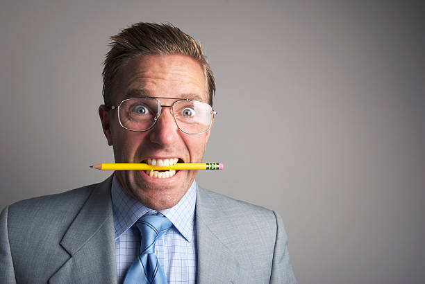 istock Angry Businessman Clenches Teeth Chewing Pencil 170058821