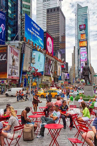 People visit Times Square in New York. The square at junction of Broadway and 7th Avenue is a famous New York landmark.