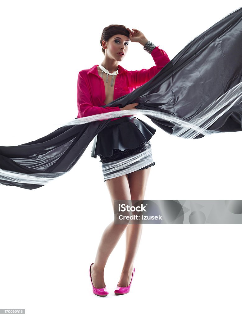 Fashionable Woman Full Lenght Portrait of Beautiful Woman Wearing Pink Top and Black Mini Skirt posing with Scarf. Studio shoot, white background. Luxury Stock Photo