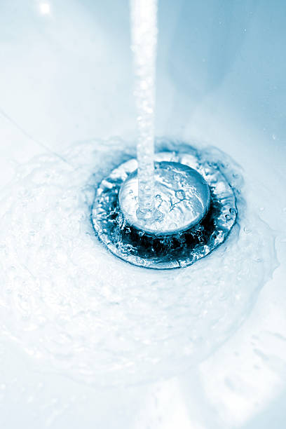 istock running water from bathroom faucet in drain 170060587