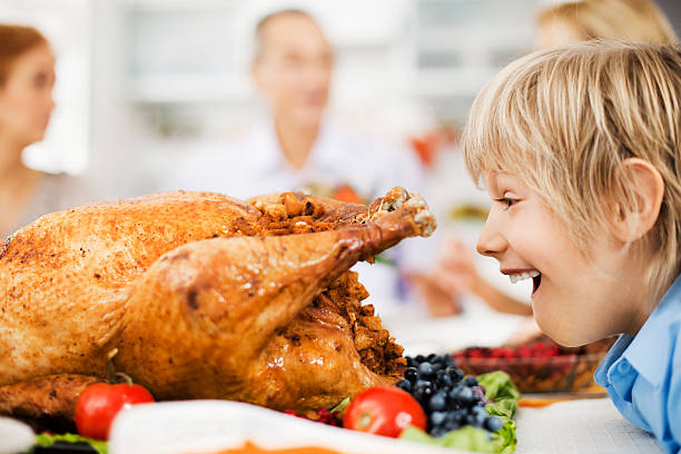 istock Surprised boy looking at stuffed thanksgiving turkey. 170061082