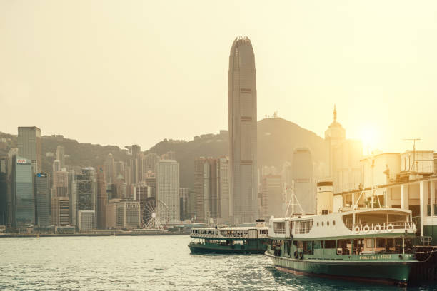 istock Hong Kong Skyline at sunset with ferry 1700618083