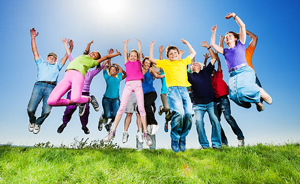 istock Large group of people jumping against sky. 170062188