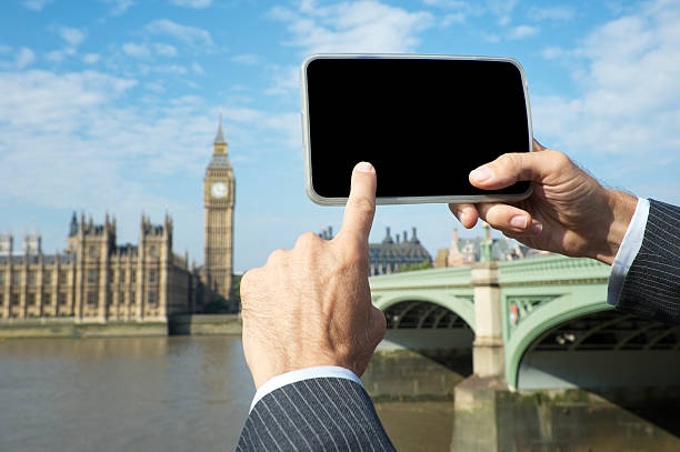 istock Businessman Uses Tablet Computer in front of London Skyline 170062370