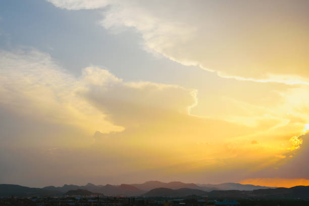 Beautiful sunset with the sun of orange tones behind the mountains and deep blue sky