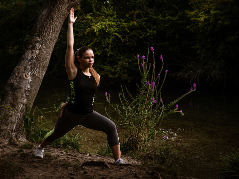 young woman practicing yoga in the countryside ,concept of health and wellbeing .