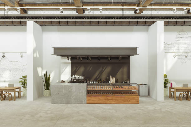 istock Empty Coffee Shop Interior With Wooden Tables, Stools, Laptop Computers, Coffee Maker And Cake Display Fridge 1700646617