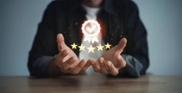 Photo of Man hand holding virtual icon providing a five-star premium service. hand man showing award high standards are guaranteed, service quality, the assurance five stars. Guarantee the quality concept.