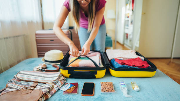 istock Woman packing suitcase for travel 1700657382