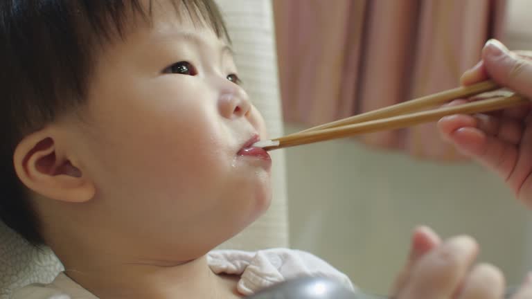 Asian little boy eating noodle food