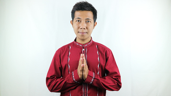 Moslem Asian man smiling to give greeting during Ramadhan, Idul Fitri, Idul Adha celebration