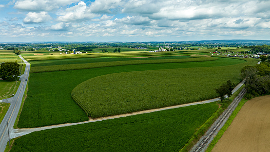 An Aerial View of Rural America, with Farmlands and a Single Rail Road Track Going Thru it.