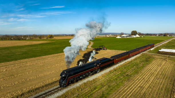 istock Drone View of a Streamlined Passenger Train Traveling Blowing Smoke 1700675328