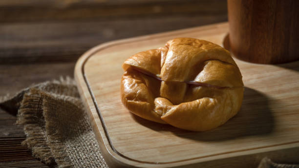 Close up Delicious Freshly Baked Croissants and cup on Rustic Wooden Platter