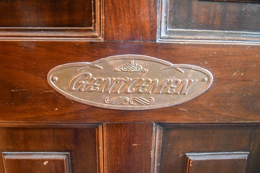 Sign indicating gender on the door of a bathroom. Gentelman