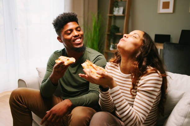 istock Young couple enjoying pizza at home 1700696549