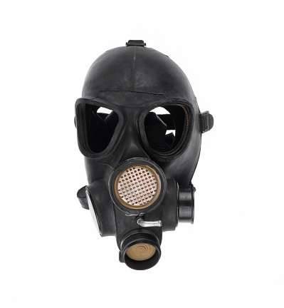 An unnerving creature stares at the viewer through the glowing eyes of a gas mask.