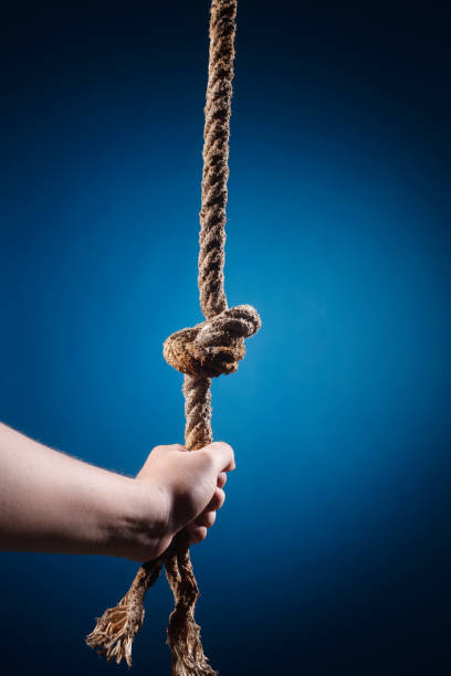 istock Hand holding onto knotted rope 1700704903