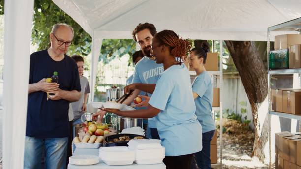 istock Volunteers Aiding The Underprivileged 1700711685