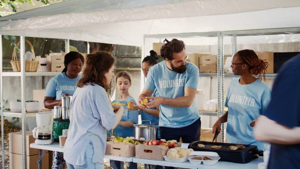 istock Volunteers Assisting The Hungry And Poor 1700713874