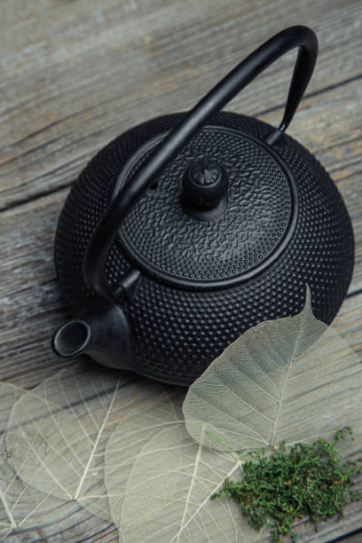 istock Black iron tetsubin teapot with some decoration made from leaf skeleton 1700717243