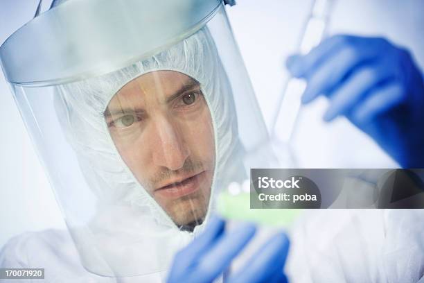 Scientists Working At The Laboratory Examining Hazardous Chemicals Stock Photo - Download Image Now