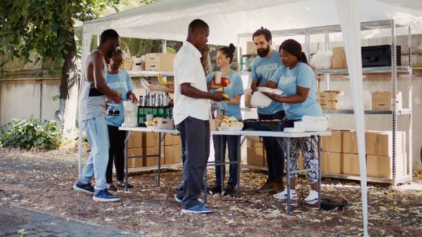 istock Volunteers Serve Warm Meals To The Poor 1700727214