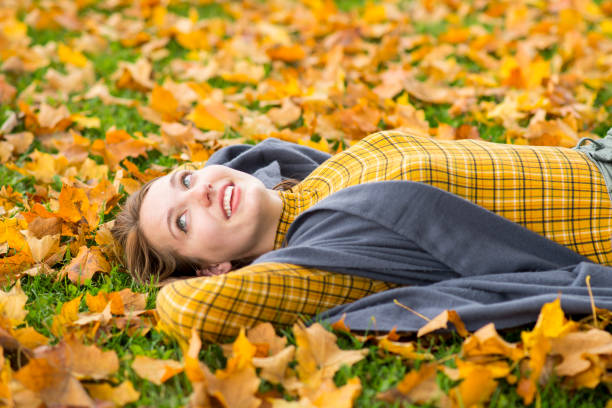 Free Stock Photo of Woman Laying in a Pile of Leaves | Download Free ...