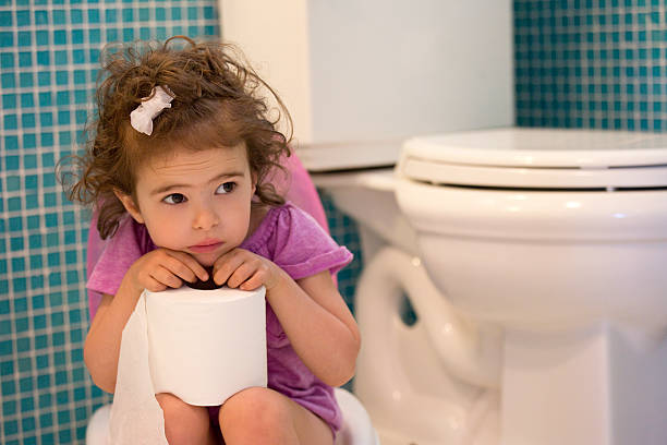 potty training concept little girl sitting on the potty in the bathroom one girl only stock pictures, royalty-free photos & images