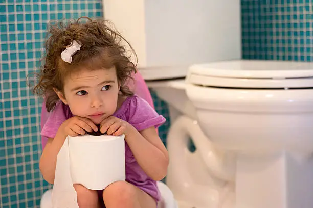 little girl sitting on the potty in the bathroom