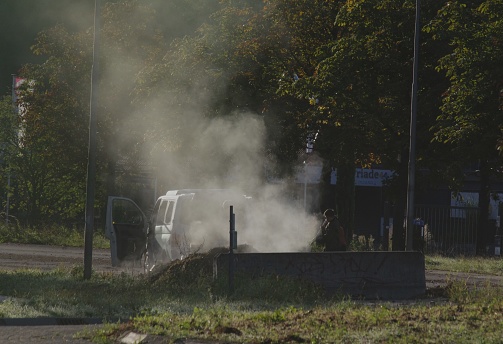 Brunssum  the Netherlands, - September 05,  2023.  Farmer loading evaporating 
 hay near the road in the early morning