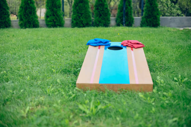 istock Blue and red beanbags sitting on blue cornhole board platform 1700808415