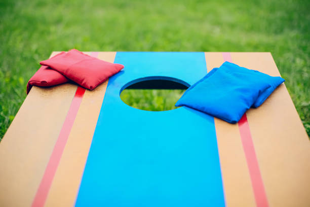 istock Blue and red beanbags sitting on blue cornhole board platform 1700808964