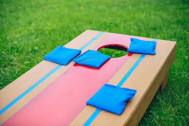 istock Blue beanbags sitting on blue cornhole board platform 1700811185
