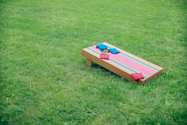 istock Blue and red beanbags sitting on blue cornhole board platform 1700811724